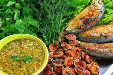 yummy cooking clam and fish with chili sauce