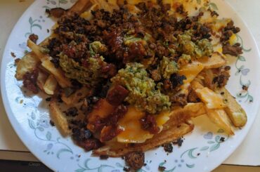 Chili cheese fries with a guac and chipotle drizzle