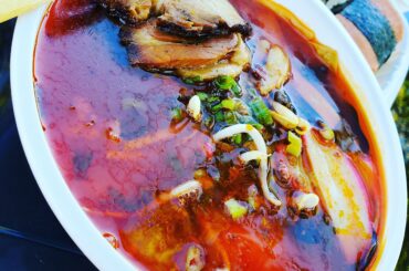 Bloody spicy ramen. Ate it in a shady area on my trunk due to the covid restrictions for takeout/curbside pickup only.