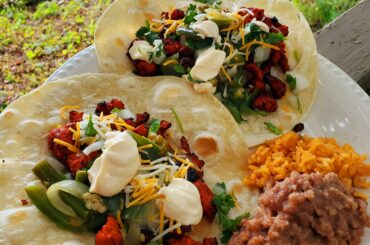 Spicy woodfired Al Pastor tacos with chopped cilantro & onions, crema salvadorian, sauteed jalapeno, shredded cheese, and all piled high on a fresh warm tortilla.