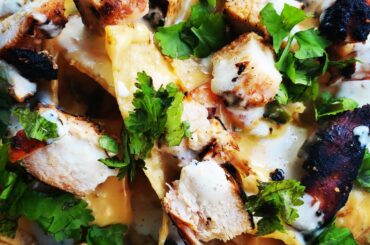 grilled chipotle chicken nachos with smoked queso & creamy roasted habanero and garlic sauce