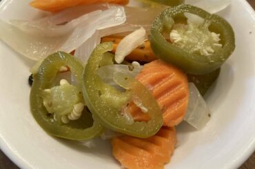 Freshly pickled jalapeños, carrots, and onions. Good as a condiment but also really great to just munch on.
