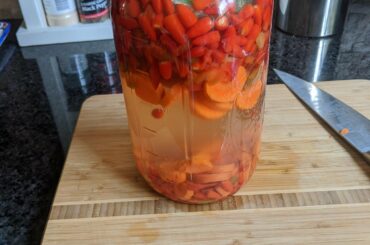 Keeping the peppers under the brine