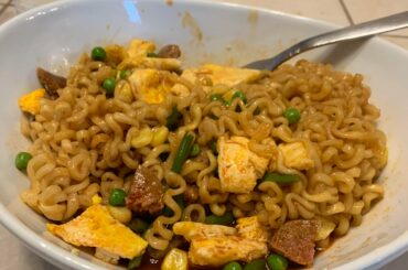 2x spicy ramen with egg, sausage, peas, corn, and string beans. Delicious.