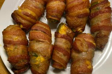 Sausage and Cheddar stuffed jalapeños wrapped in bacon.