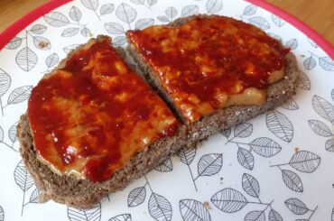 A slice of bread with extra chunky peanut butter and a generous layer of sambal oelek on top. Such a good lunch.