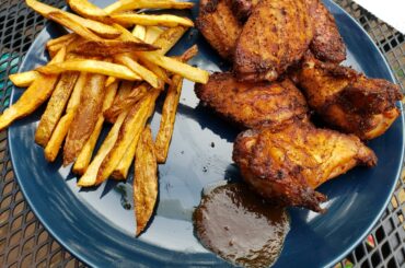 Smoked wings, with a dragon cayanne/ chipotle pepper rub. Saddled with home cut fries and a puddle of my smoked habanero coffee sauce for dipping.