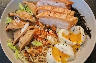 Homemade spicy chicken gyozas, spicy miso broth, crackly skin pork belly, soft boiled eggs, topped with some fresh Birdseye chillis, seaweed and scallions!