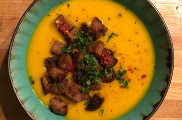 Pumpkin soup with homemade croutons, parsley and dried homegrown ghost pepper