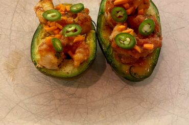 Broiled avocados filled with shrimp cooked in my fresh ghost pepper salsa, topped with an orange citrus hot sauce, carrots, green onions and Serrano peppers.