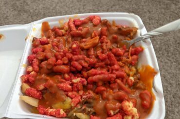 Chili cheese fries with extra hot cheetos topped with black label Valentina's hot sauce.