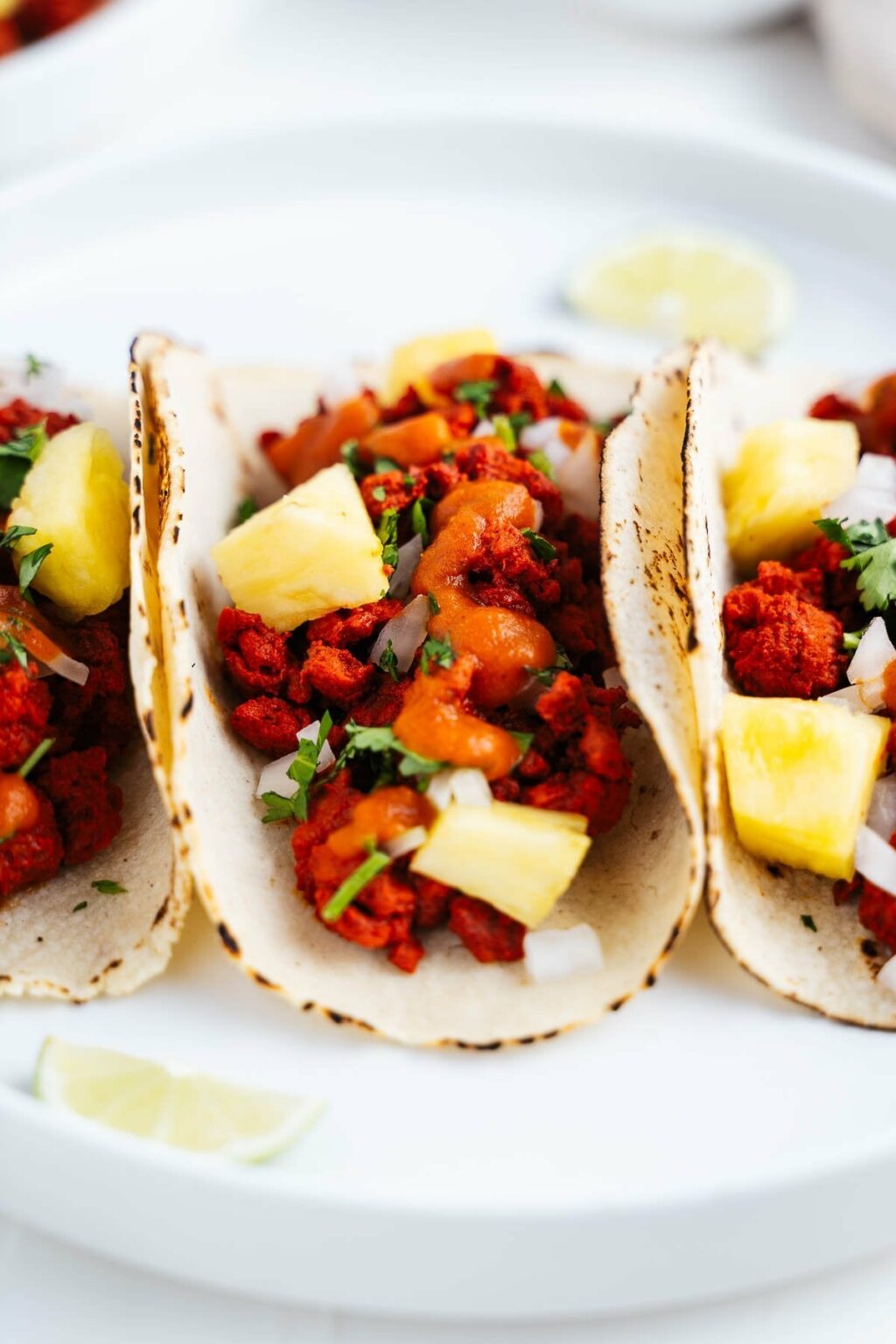 Tacos al pastor (plantbased) made with dried guajillo & chipotle chilies, topped with a spicy