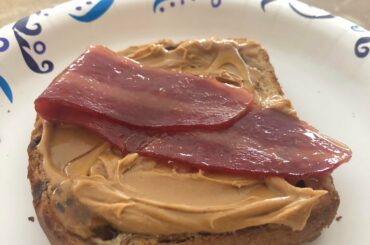Toasted cinnamon swirl raisin bread with creamy peanut butter, honey, and turkey bacon glazed in brown sugar and mango habanero jelly.