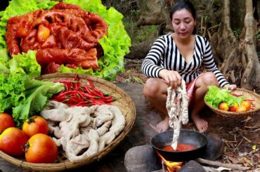 Cooking Pig intestines spicy chili curry with tomato in the forest taste delicious
