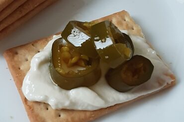 Cowboy Candy on ricotta and a cracker, perfect lazy Saturday snack.
