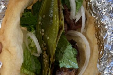 Rez food classic. Roast mutton, roasted hatch green chili, lettuces and onion all wrapped in fluffy fry bread. Simple and delicious.