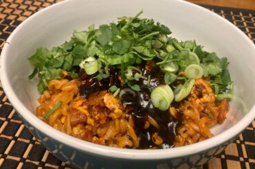 Samyang 2x wi the bacon, an egg, garnish, and a bunch more capsaicin reduction pan sauce over the top