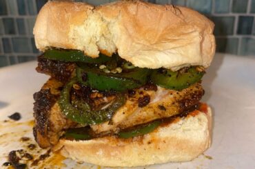 Chicken Thigh, brined, then covered in Chili and Cayenne Powders, Cajun Rub, with roasted Jalapeno, Sriracha, Scotch Bonnet sauce, on a roll