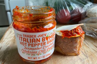 Calabrian chili spread with basque cheese on a cracker