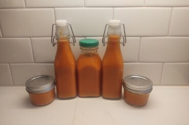 First pepper growing success! Got ~40 oz of homemade hot sauce using Calabrian and Santa Fe peppers from my garden and Palisade Peaches for sweetness