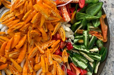 I use a pizza pan with holes in the bottom to smoke a big batch of peppers, then make several small batches with different blends, from mild to scorpion.