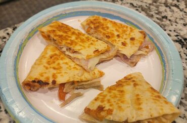 Oaxaca and chicken quesadilla with shallots and honey fermented aji amarillo