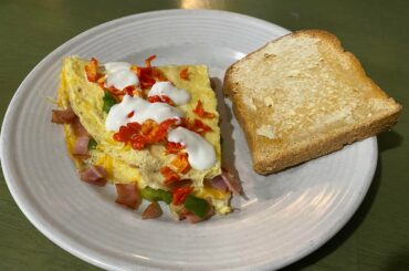 Omelette topped with Carolina Reaper and fresh crema