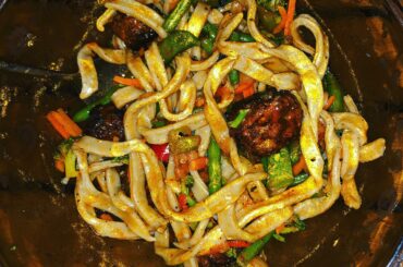 Homemade garlic udon, broiled Beyond meatballs, veggies, and gochujang-Carolina reaper sauce