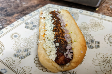 Spicy dog. Black and blue hot dog.