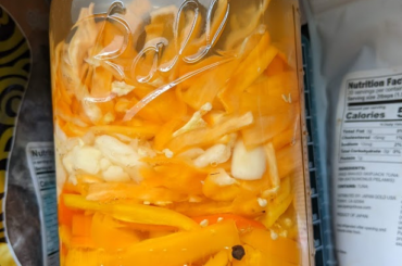 Sweet bell, manzano, and habanero peppers fermenting with some garlic. Going to end up emulsified with butter for wings.