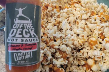 Spicy popcorn made with a habanero/scorpion pepper hot sauce infused popping oil and cayenne , onion and garlic butter.