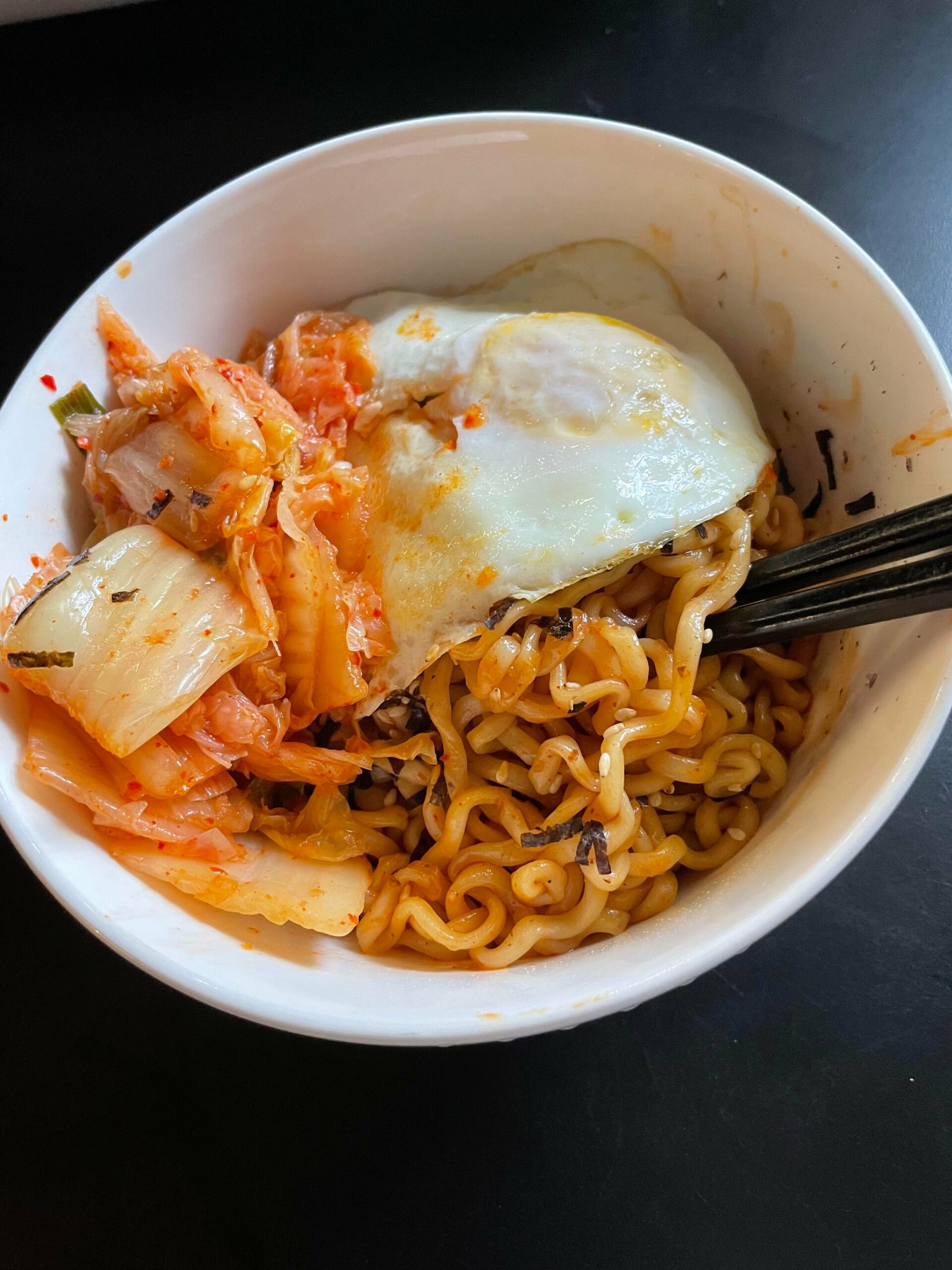 Buldak spicy chicken ramen with kimchi and a fried egg. Chili Chili