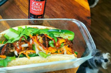 Vietnamese/Filipino fusion: meatball banh mi, meatballs are made of lumpia filling. Topped with gochujang hot sauce.