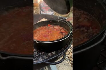 Fire hot chili for nachos tonight , simmering away on the fire pit #dutchoven #embers #chili #mexico