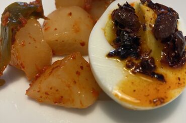 Snacktime: egg with chili crisp and daikon kimchi [homemade besides the egg - of course]