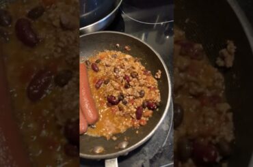 Making chili dogs with chips on the side