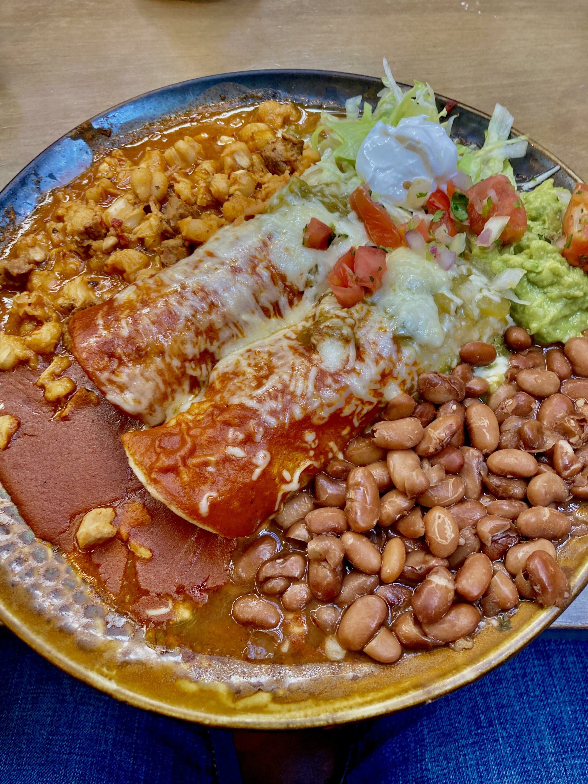 Christmas style chicken enchiladas with pozole, pinto beans, salad