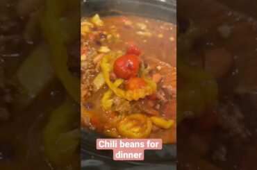 Crockpot chili beans with Jiffy, topped with sour cream and shredded cheddar cheese