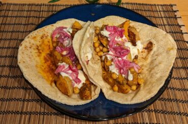 Roasted curried squash and chickpeas with Naga pickle, mango chutney yoghurt, and pickled red onion on sourdough naan