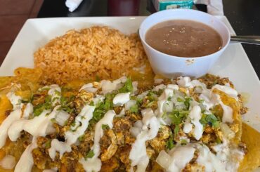 Breakfast of Champions! Chilaquiles with chorizo added topped with crema and green salsa!