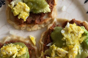 Sopesitos with frijoles, salsa verde, eggs, cheese, and onions!