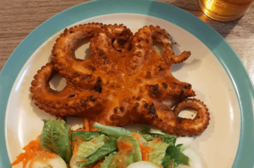 Grilled octopus with salad and a Modelo