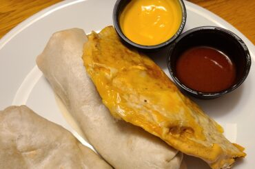 Shredded beef taco with dipping sauce and burrito