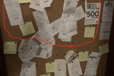 receipt wall. circled in red are Taco Bell receipts, outside the circle is everything else