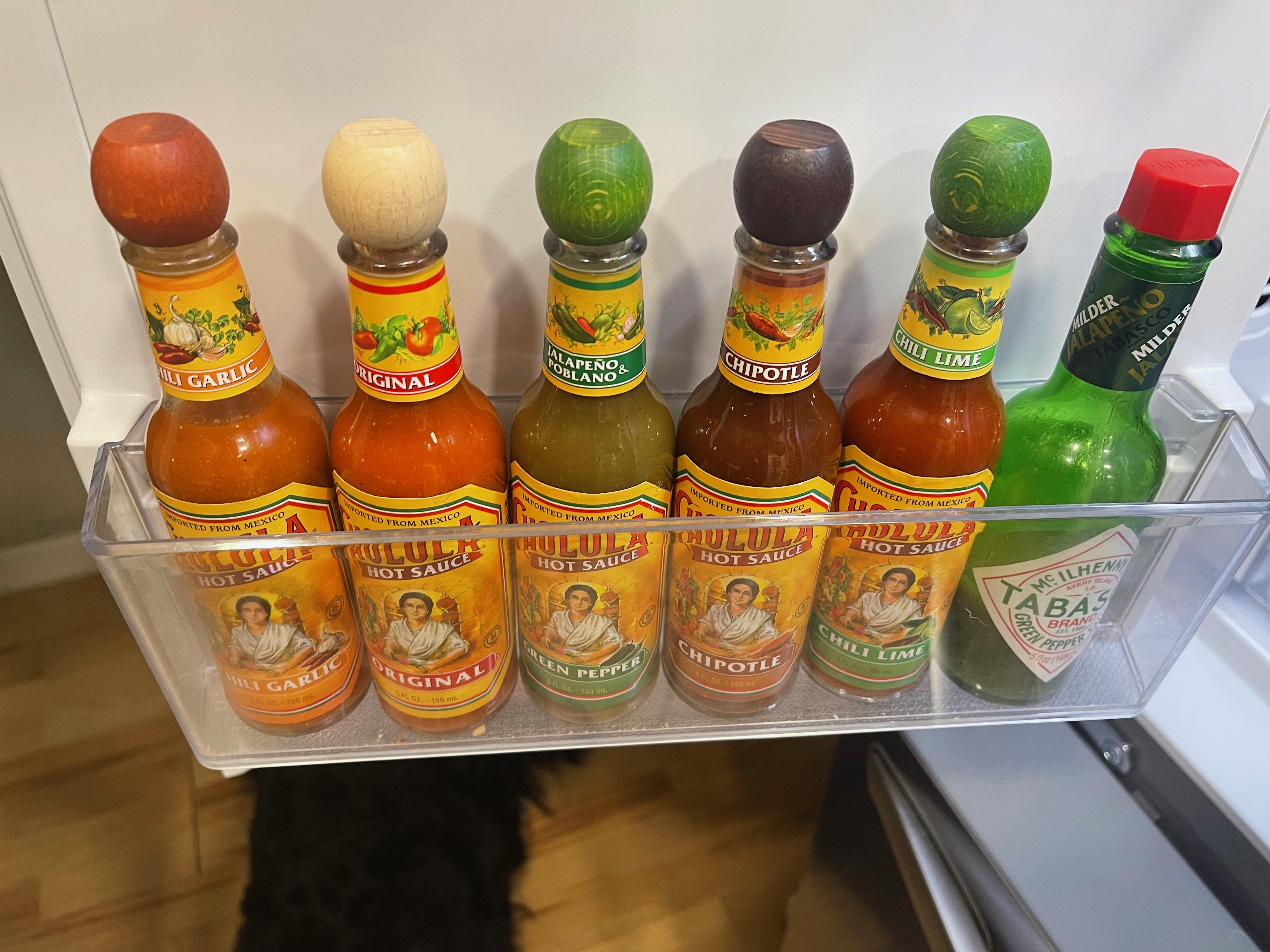Had to fill the "hot sauce" shelf in our new fridge. Not shown Melinda's variety pack Chili Chili