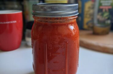 An entire season of growing peppers (both bell and chilli) and tomatoes culminated in 500 mL of tasty fermented hot sauce!