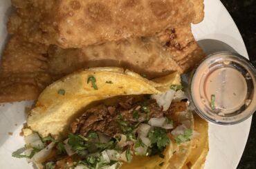 Carnitas & al pastor tacos with barbacoa empanadas and rasada.
