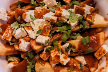 Papas fritas con chile colorado y queso fresco served in a Poutine style.