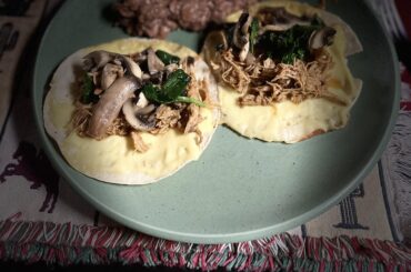 Shreded pork in chile colorado quesadilla, topped with spinach and mushrooms