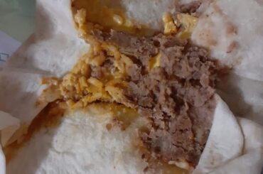 The inside of my cheesy bean and rice taco looks so sad.